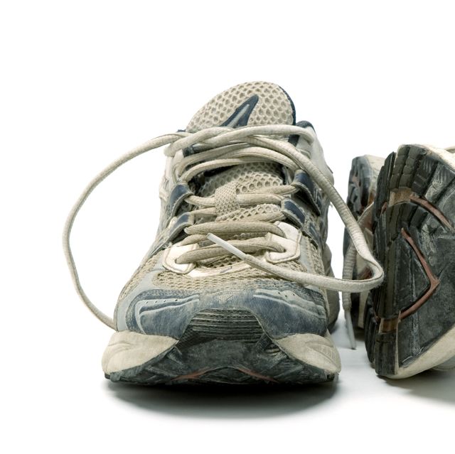 pair of old used running Rase shoes isolated on white background