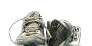 pair of old used running shoes isolated on white background