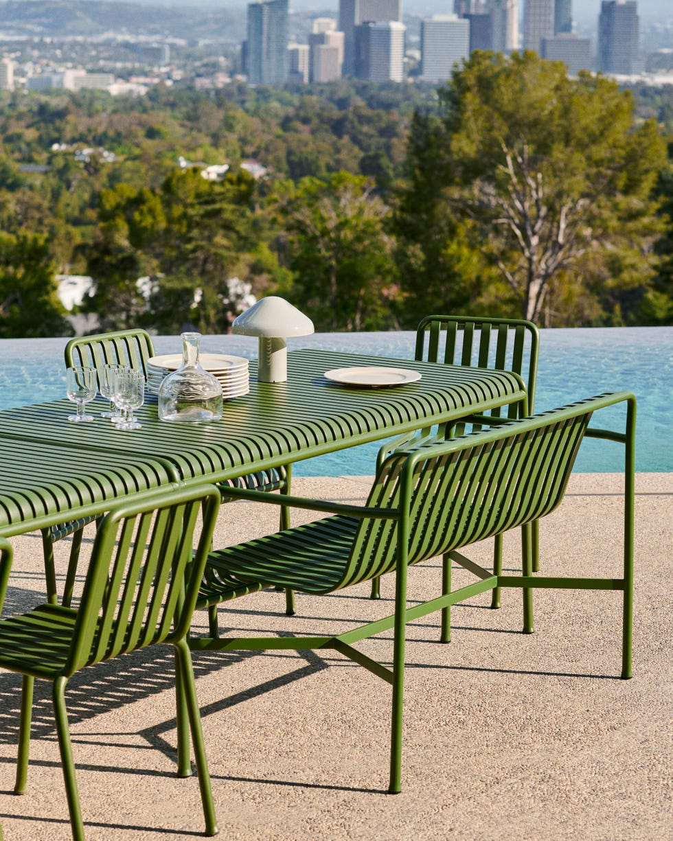 a table with plates and glasses on it by a body of water