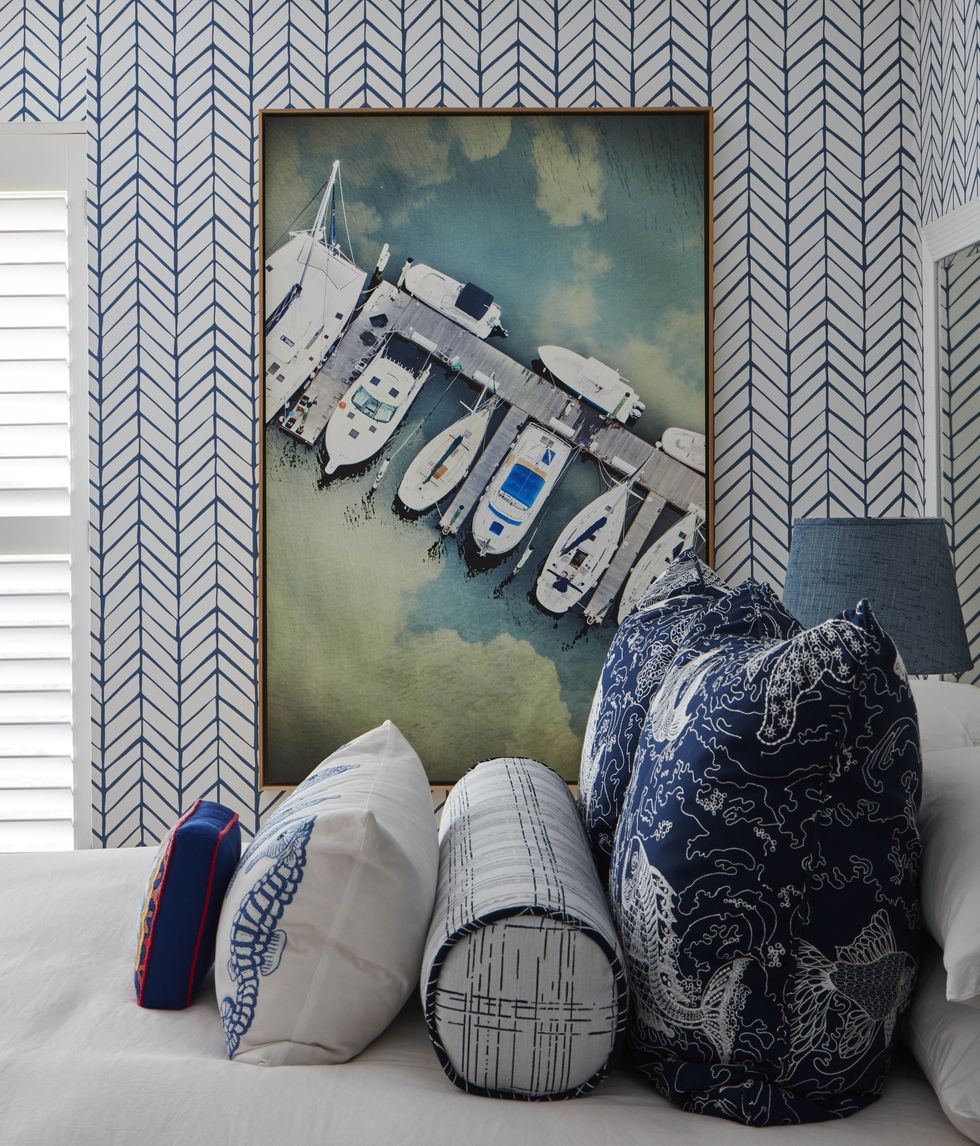 bedroom, queen bed, decorative pillows, white and blue geometric wallpaper