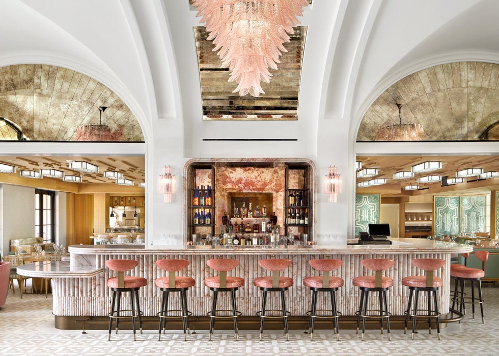 stylish bar area with seating and a variety of liquor displayed