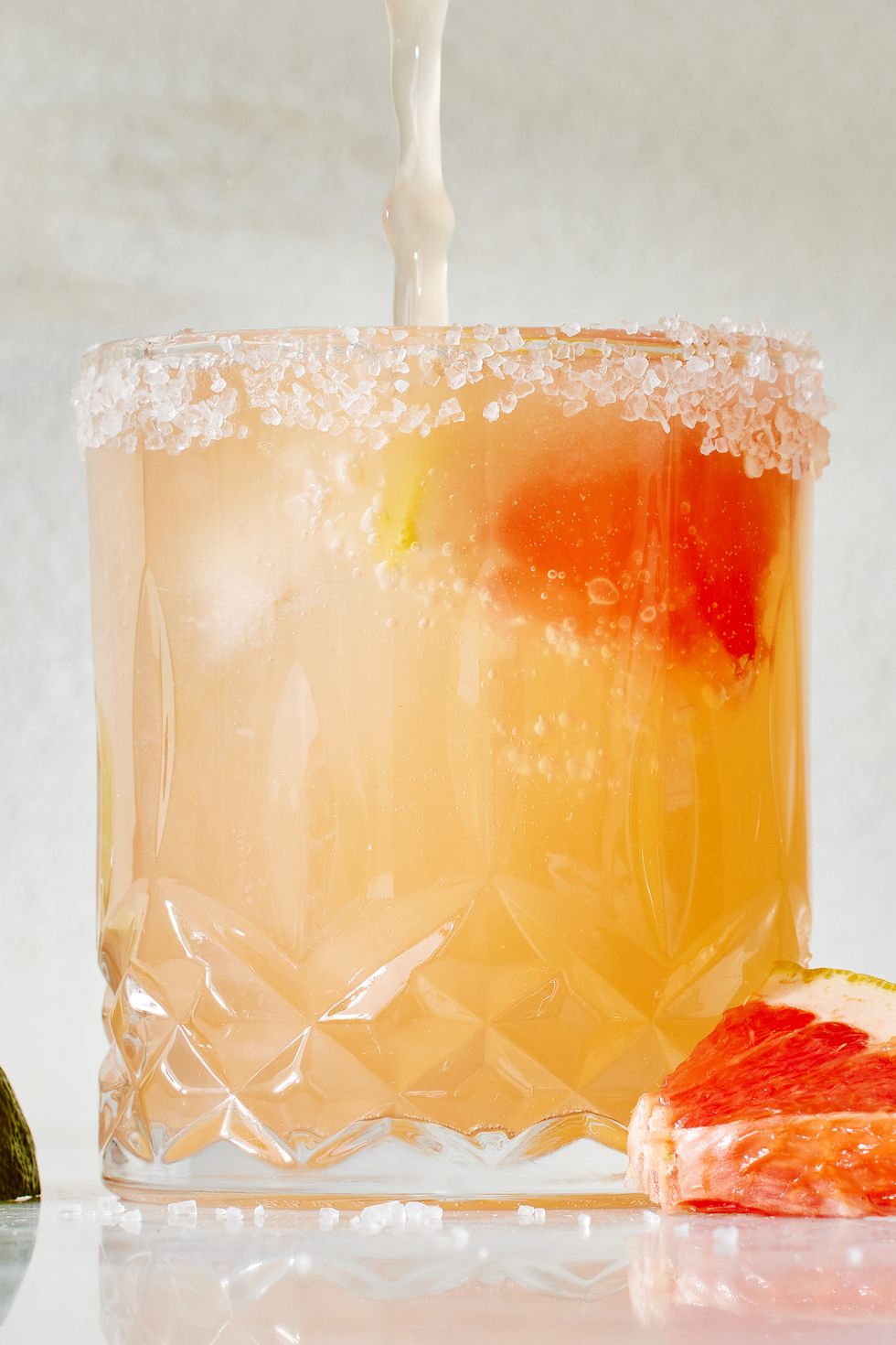 paloma cocktail with a salt rim and grapefruit garnish