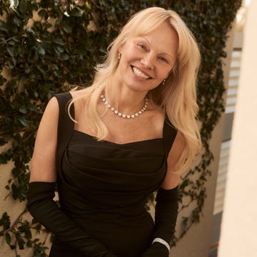 Pamela Anderson at the 2025 Golden Globes pamela anderson wearing an elegant black dress with long gloves and a diamond necklace