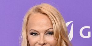 pamela anderson attends the los angeles lgbt center gala at fairmont century plaza on april 22, 2023 in los angeles wearing her hair down and smiling at the camera