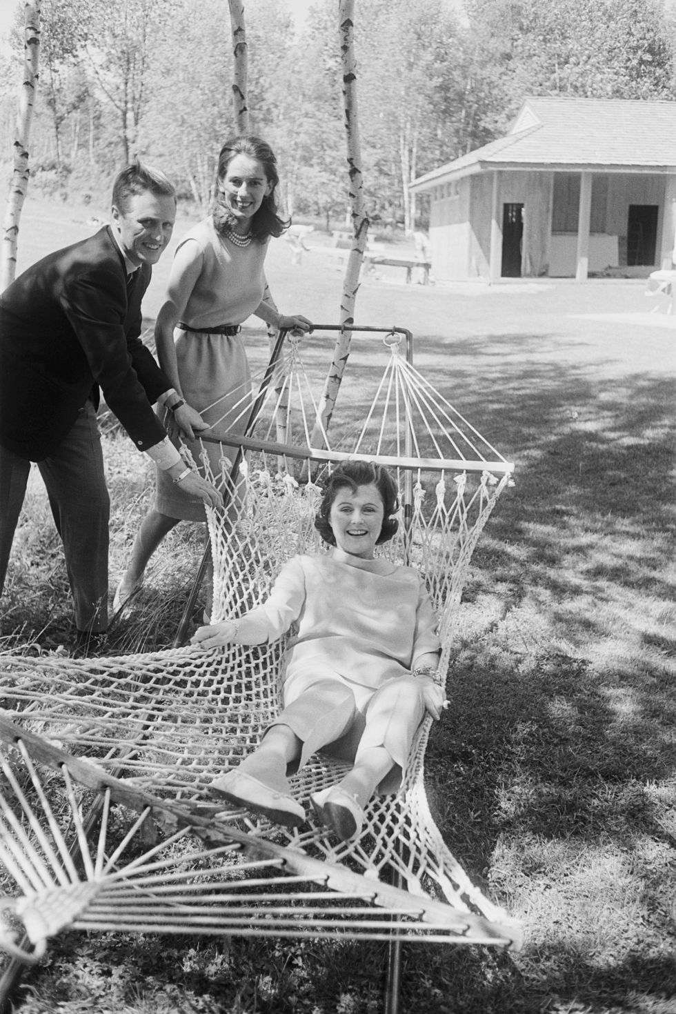 pamela churchill hayward rocked in hammock by her son winston and his finacee minnie derlanger  location mount kisko, new york, usa