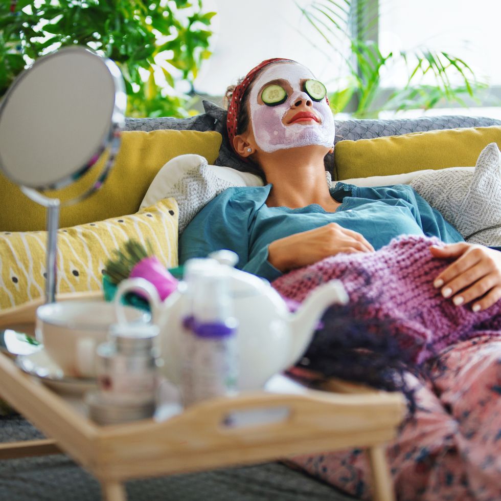 a relaxed teen with a face mask, cucumbers on her eyelids and other spa and makeover paraphernalia