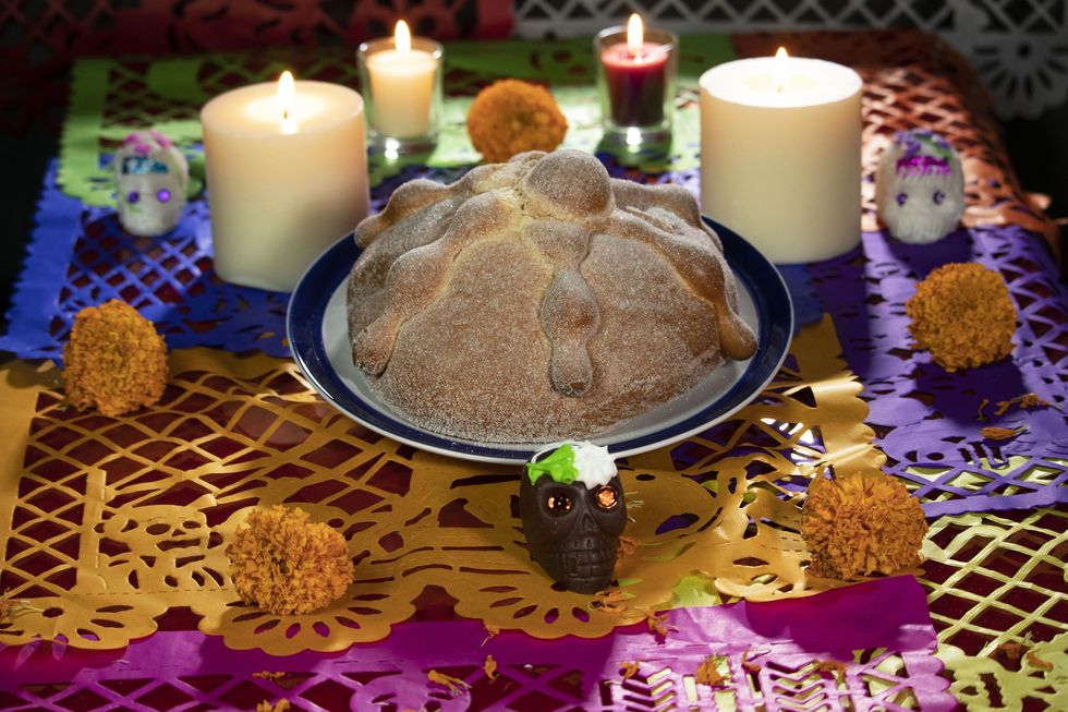 mexican offering with bread of the dead and skulls