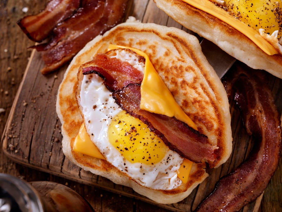pancake breakfast taco with suny side up eggs, bacon, cheese