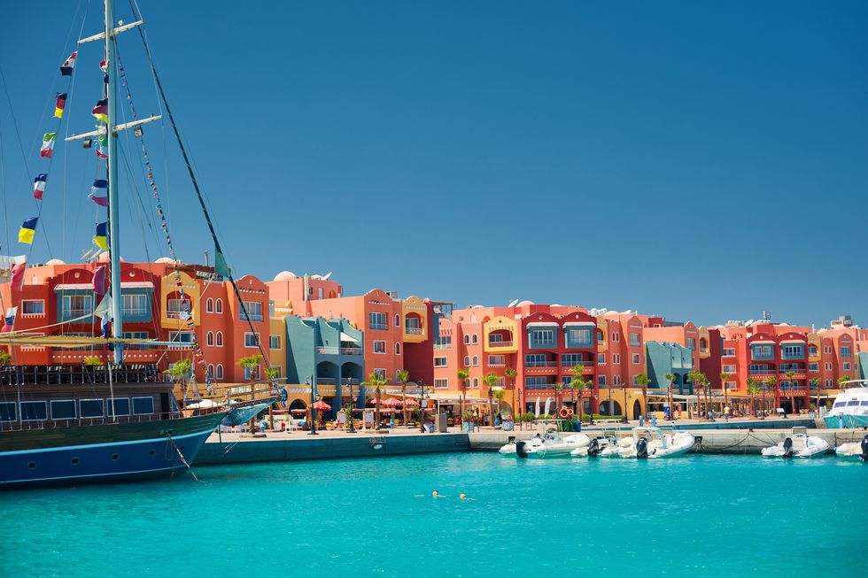 panoramic seascape on colorful marina promenade street from red sea with moored motor yachts marina, hurghada, egypt