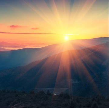 Panoramic view of  colorful sunrise in mountains.