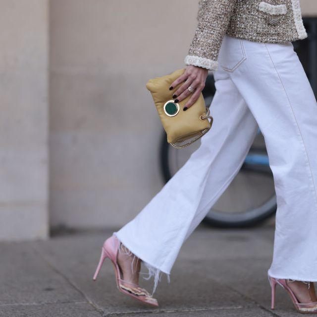 paris, france september 29 a guest seen wearing a beigewhite jacket with silver button details, a straight leg white pants, a yellow bag and rose pointed shoes with white details, outside the giambattista valli show during the womenswear springsummer 2024 as part of paris fashion week on september 29, 2023 in paris, france photo by jeremy moellergetty images