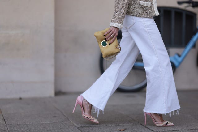 paris, france september 29 a guest seen wearing a beigewhite jacket with silver button details, a straight leg white pants, a yellow bag and rose pointed shoes with white details, outside the giambattista valli show during the womenswear springsummer 2024 as part of paris fashion week on september 29, 2023 in paris, france photo by jeremy moellergetty images