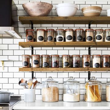 a kitchen with shelves with jars