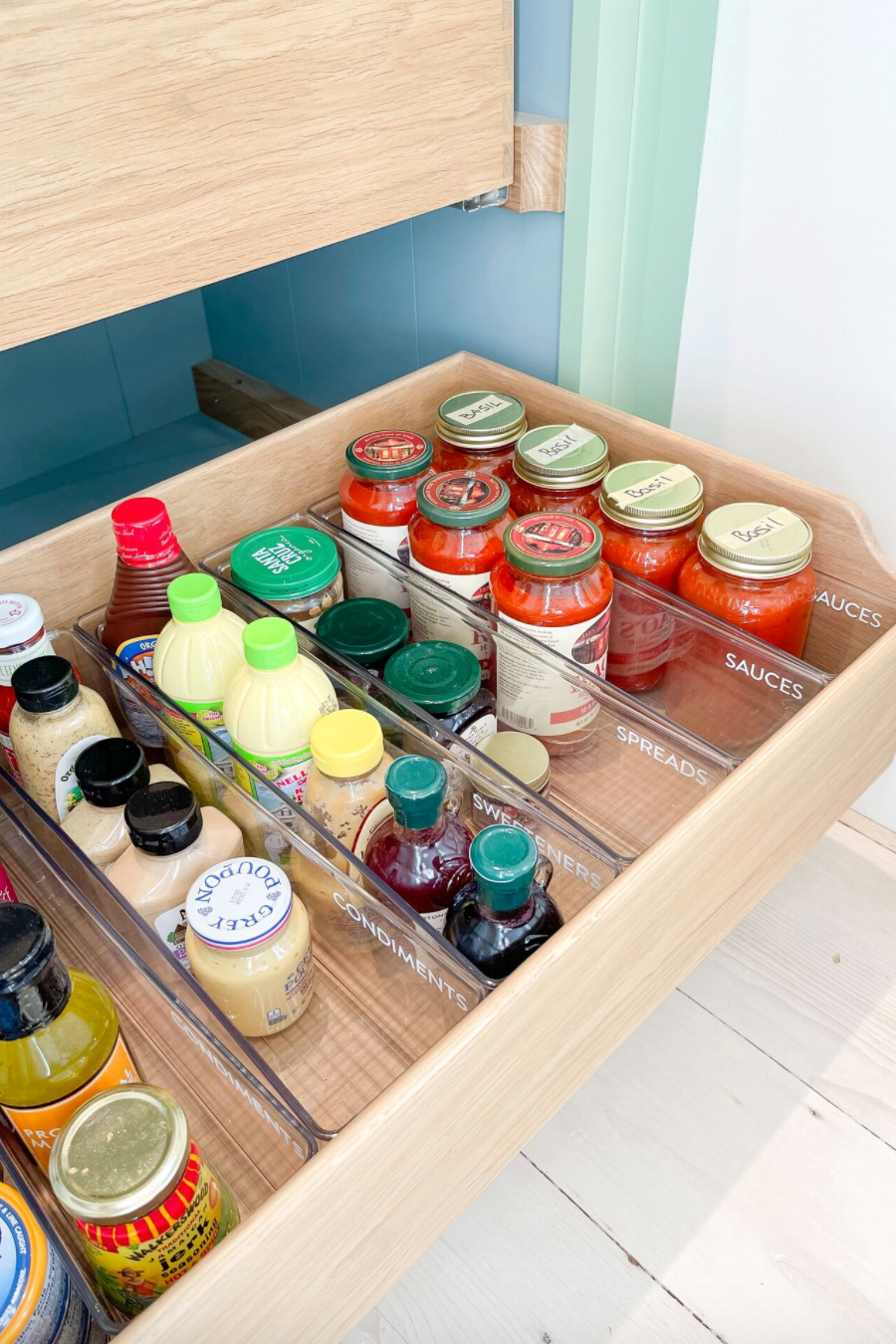 pantry organization ideas labeled bins in the open wood drawers with jars