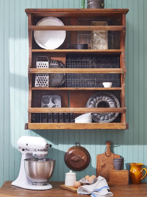 plate rack in a pantry with a stand mixer and pans