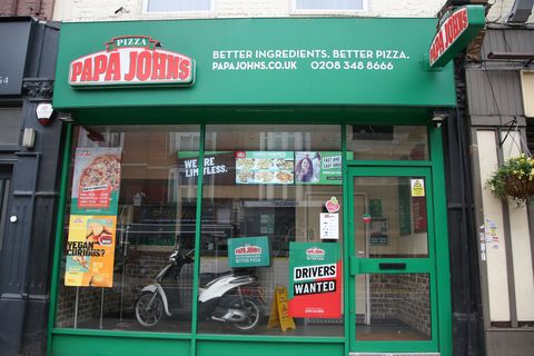 papa johns logo is seen at one of their branches