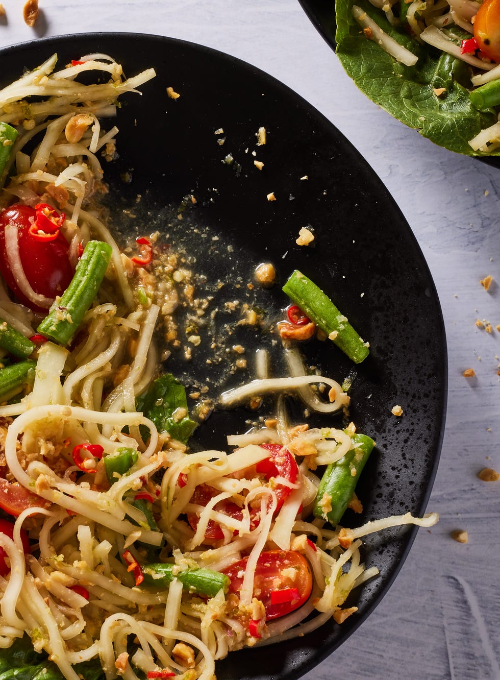 green papaya salad with tomatoes and romaine and crushed peanuts