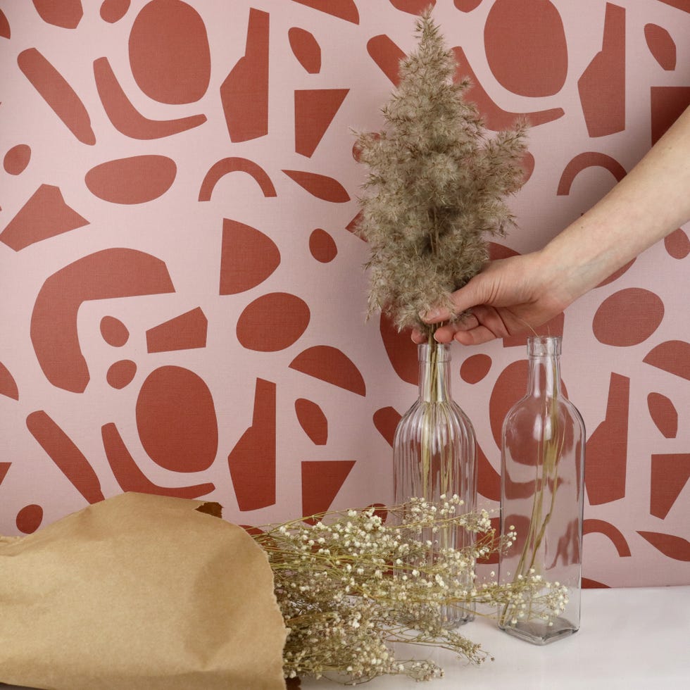 papel pintado con motivos gráficos abstractos en rosa y rojo