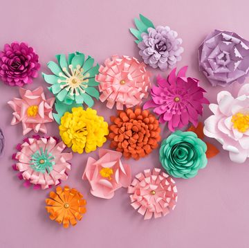 colourful handmade paper flowers on pink background