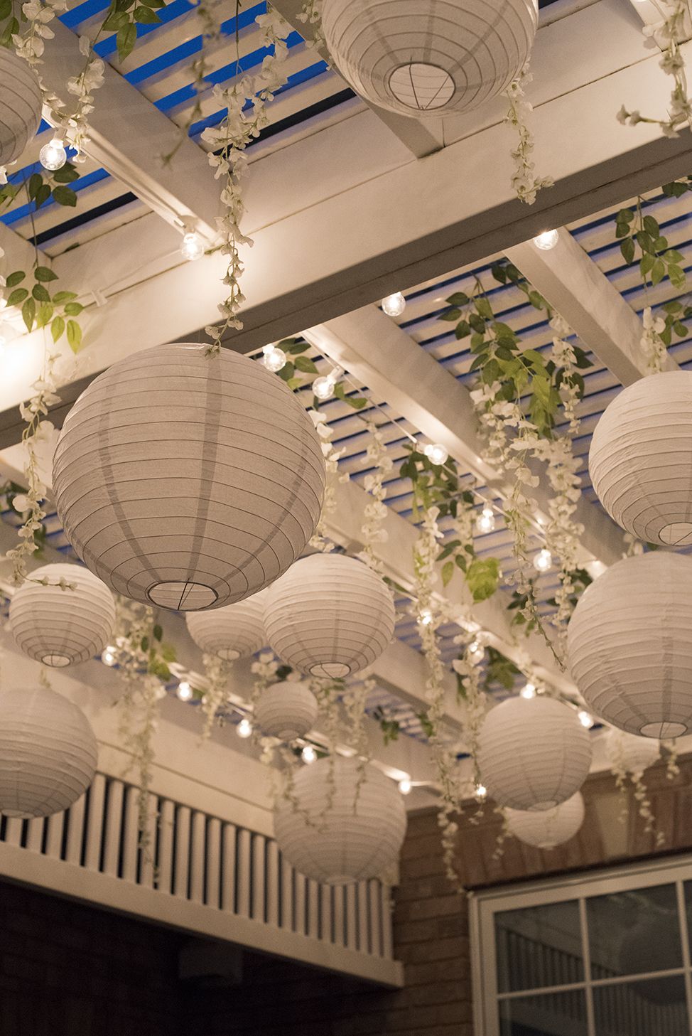paper lanterns and fairy lights on a pergola