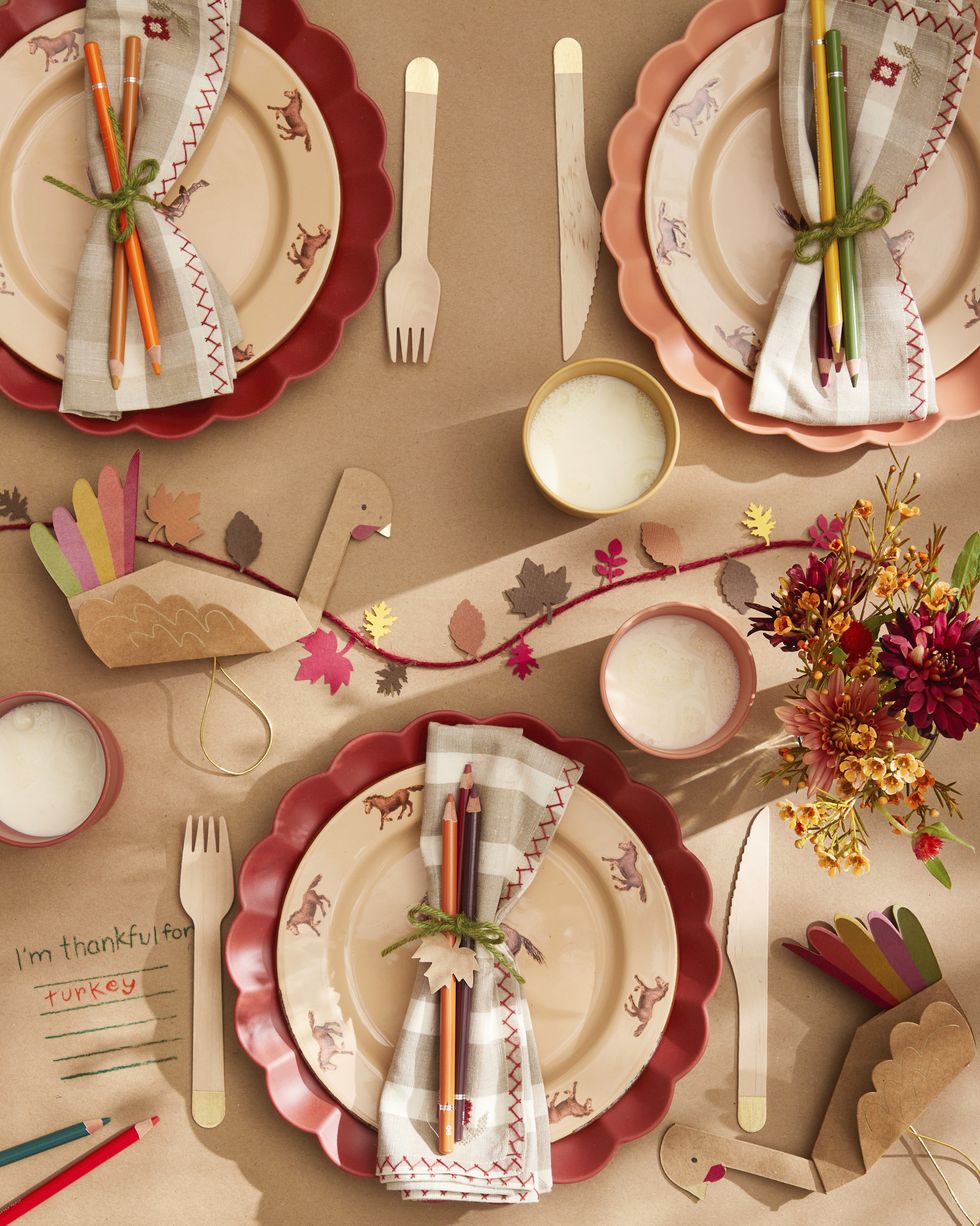 kids' thanksgiving tablesetting with paper leaf garland