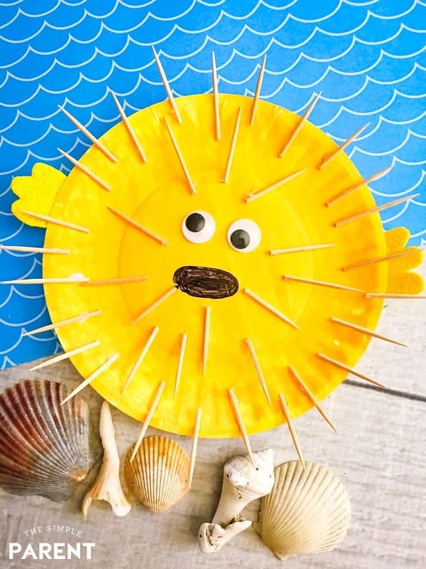 craft representation of a sun with a face and sea shells