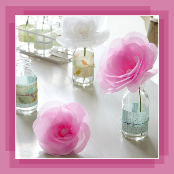pink paper roses in glass vases