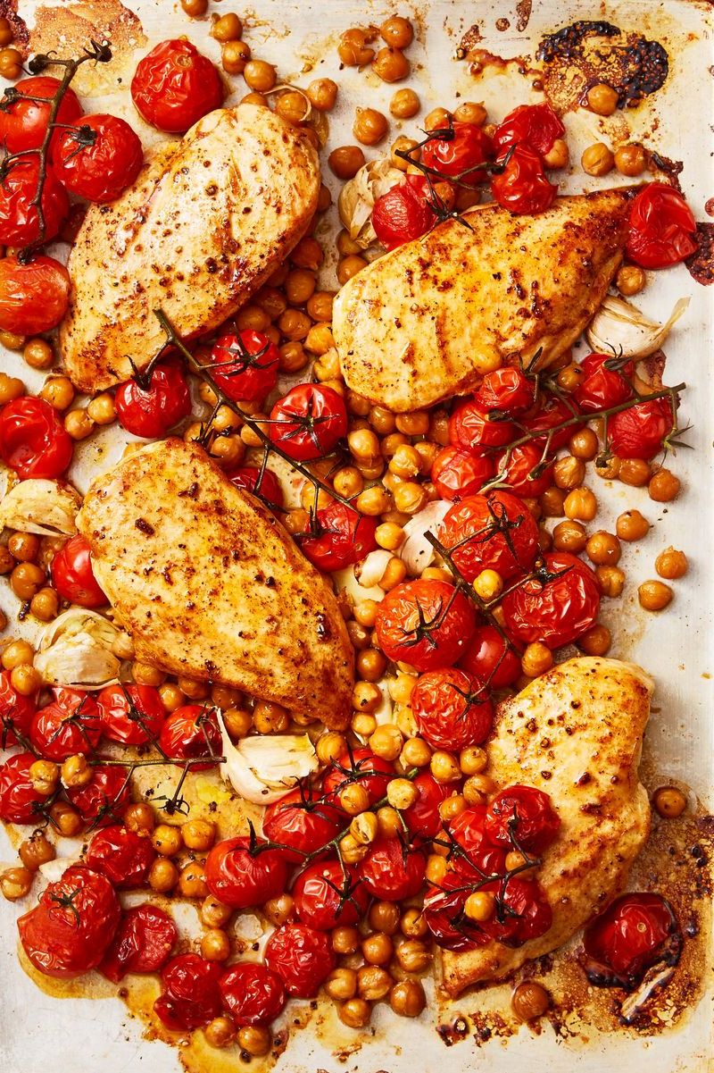 paprika chicken with crispy chickpeas and tomatoes on a sheet pan
