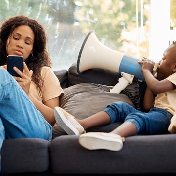 Shot of a little boy talking to his mother through a megaphone at home can you hear me now