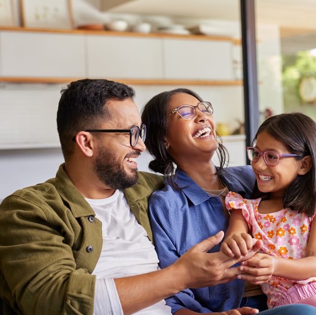 parents playing with daughter at home