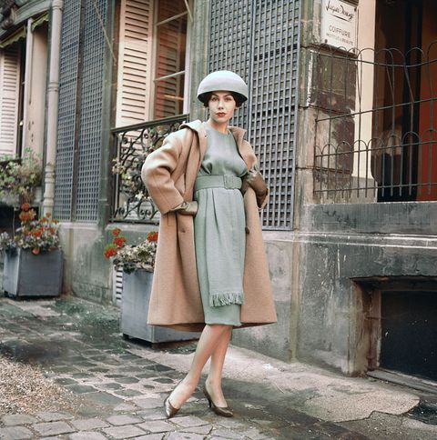 Model Posing in Dress and Wool Coat