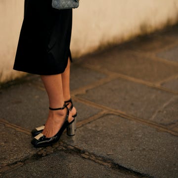 a woman wearing a black skirt and heels