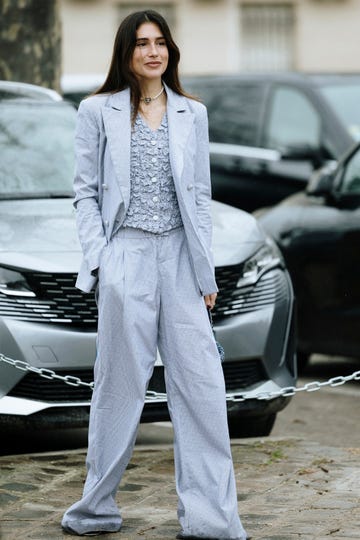 a woman standing in front of a car