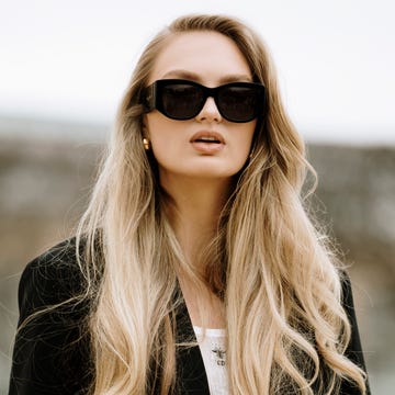 a woman with long hair wearing sunglasses