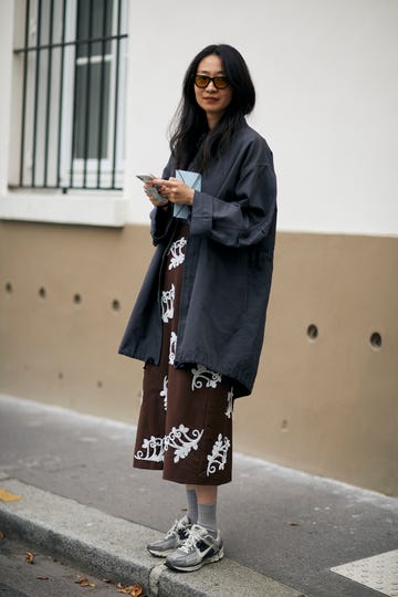 a woman in a long coat