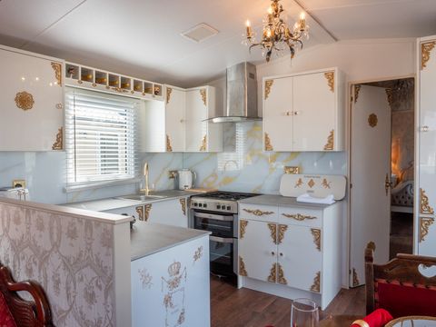 open space white and gold mobile home kitchen