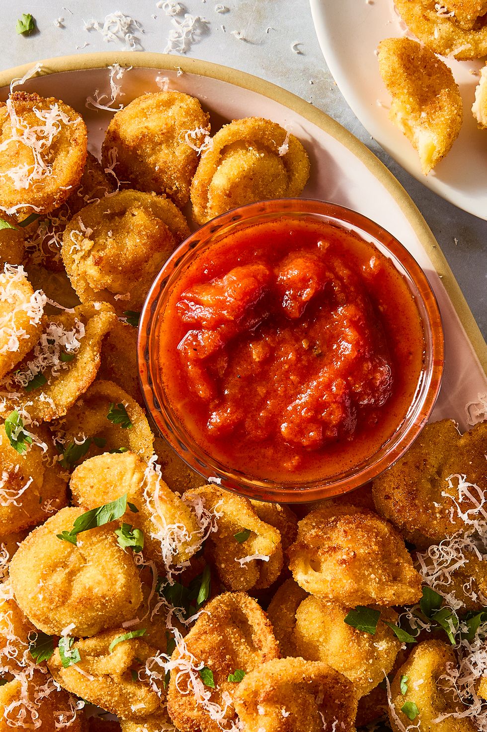 fried bites of tortellini topped with parmesan and served with marinara sauce
