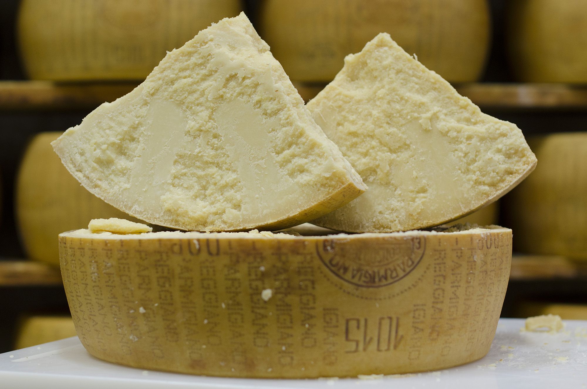 opening a wheel of parmesan cheese (parmigiano reggiano) 