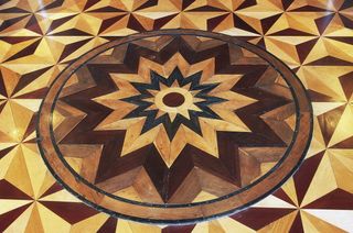 Parquet with geometrically-patterned rosette...
