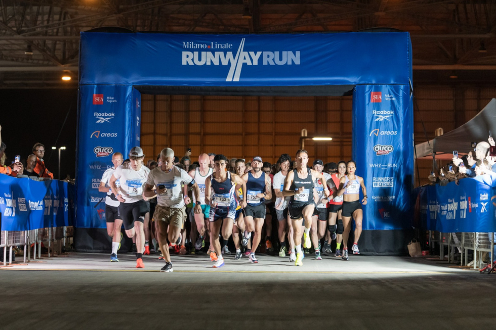 a group of people running on a track