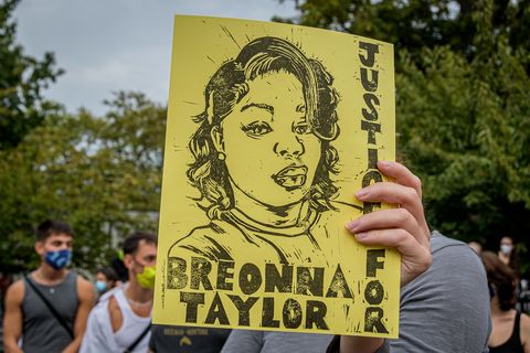 a participant holding a justice for breonna taylor sign at a protest