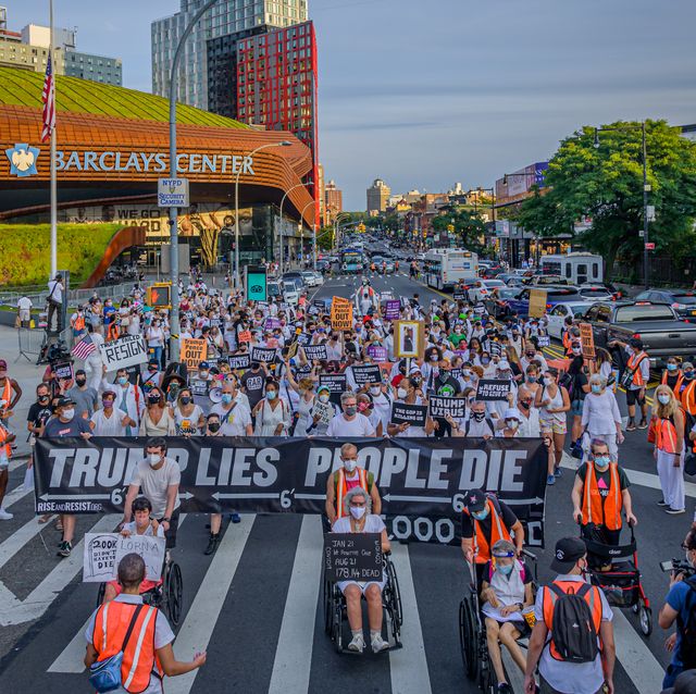 participants taking the streets while holding a trump lies,