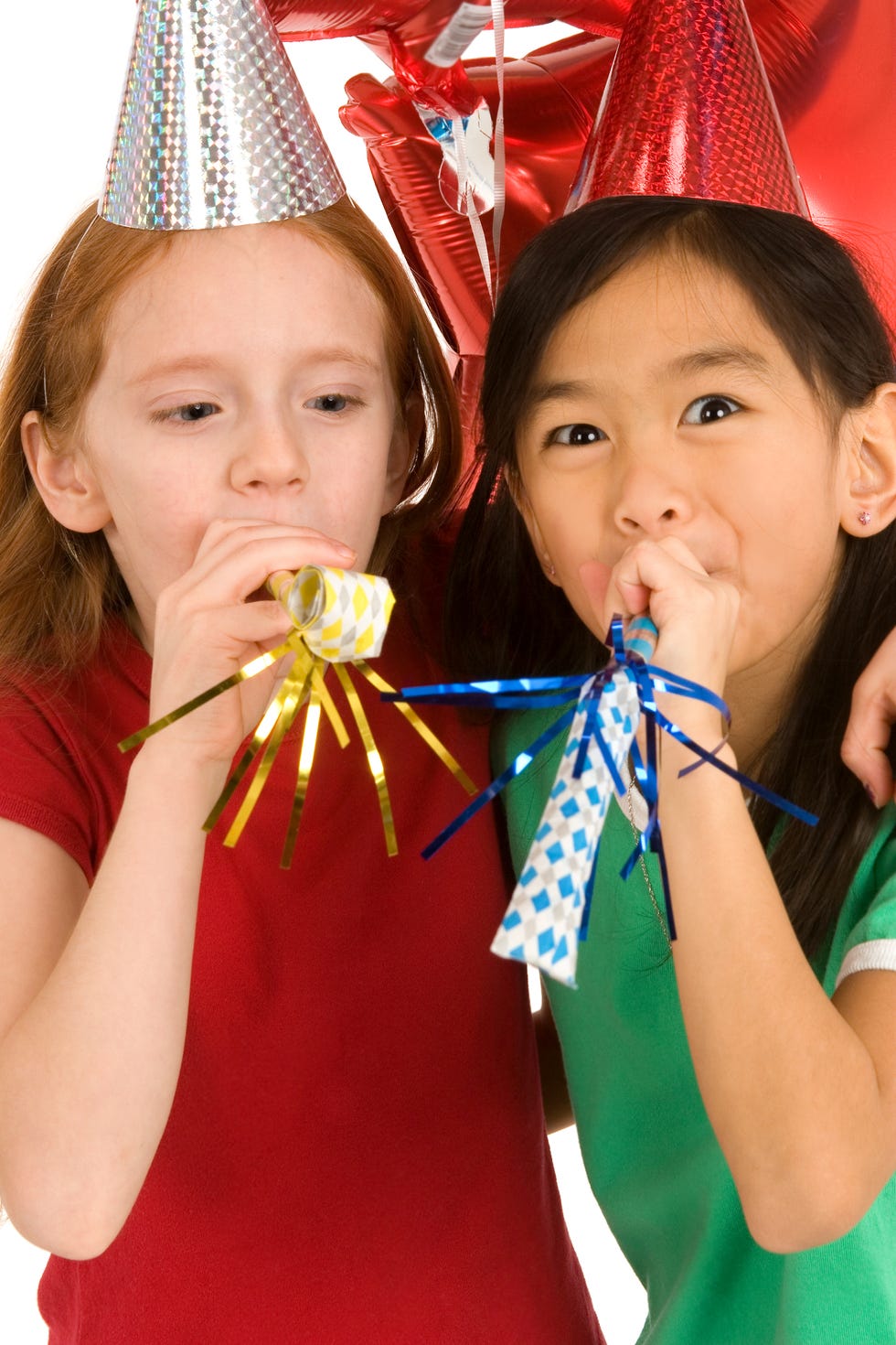 Party girls blowing noisemakers