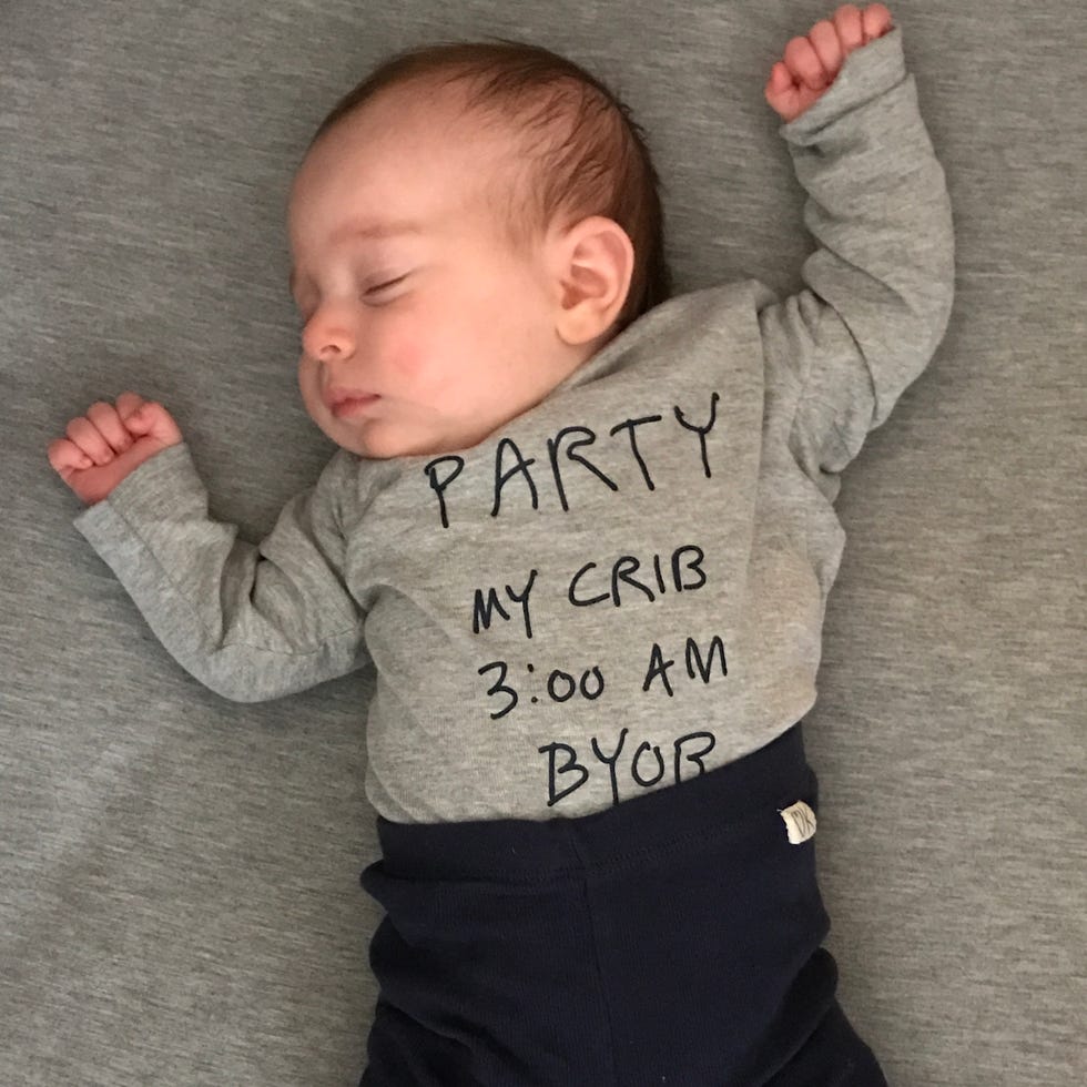 how much should you spend on a crib baby lying in a crib with a bodysuit that says party in my crib 3 am bring your own bottle