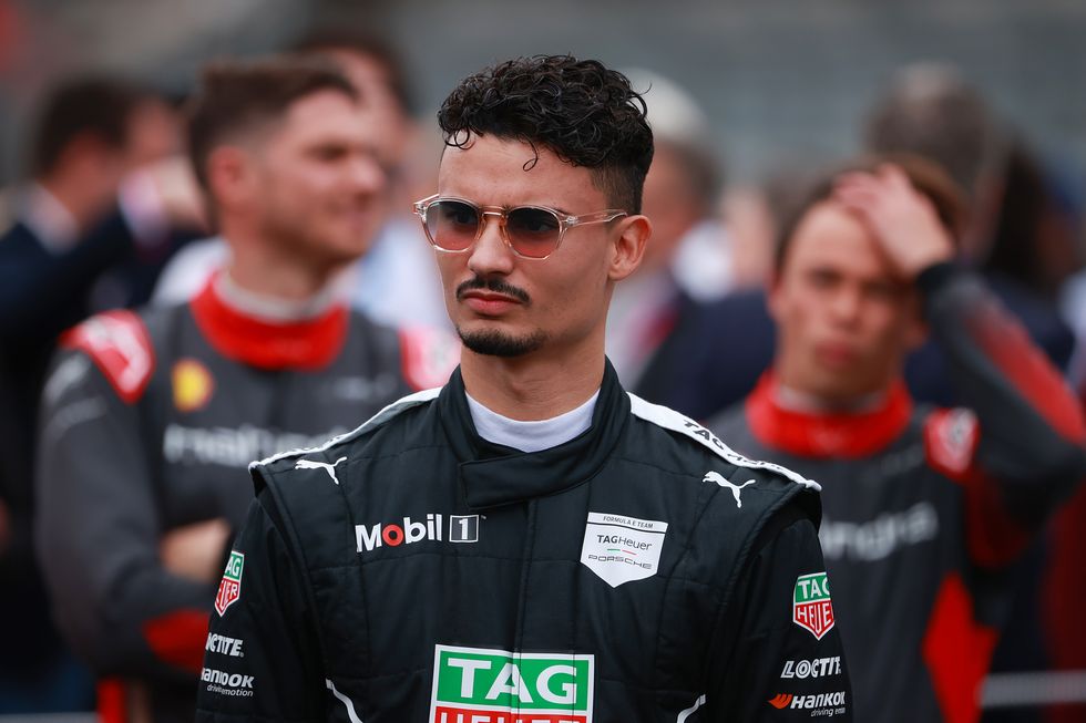 formula e driver pascal wehrlein, wearing his racing overalls and sunglasses, looks thoughtful as he waits on the grid before an eprix