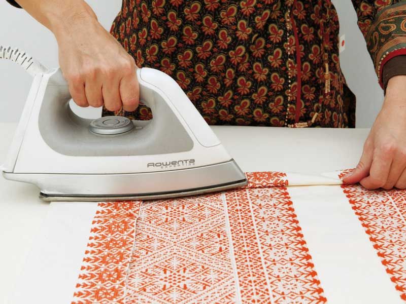 Clothes iron, Small appliance, Home appliance, Iron, Hand, Floor, Flooring, Design, Textile, Table, 