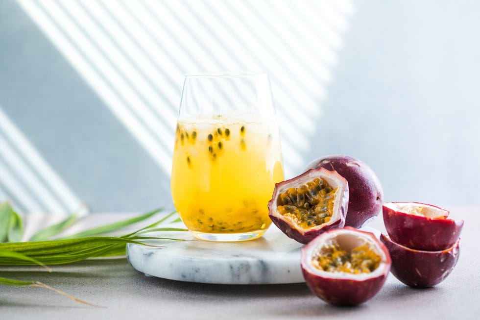 passion fruit cut up next to drink