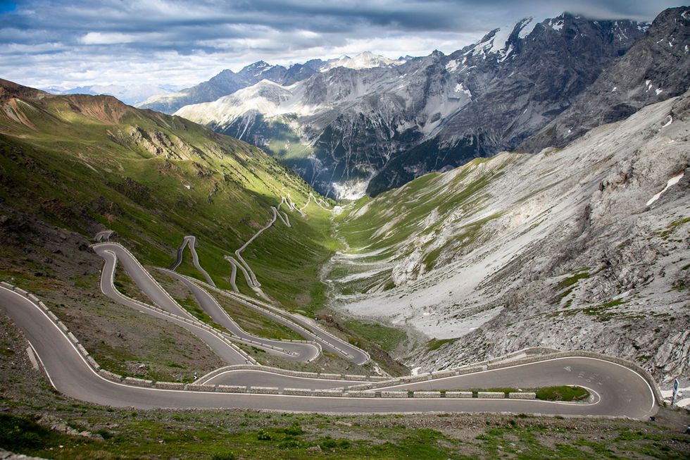 a winding road through a mountain range