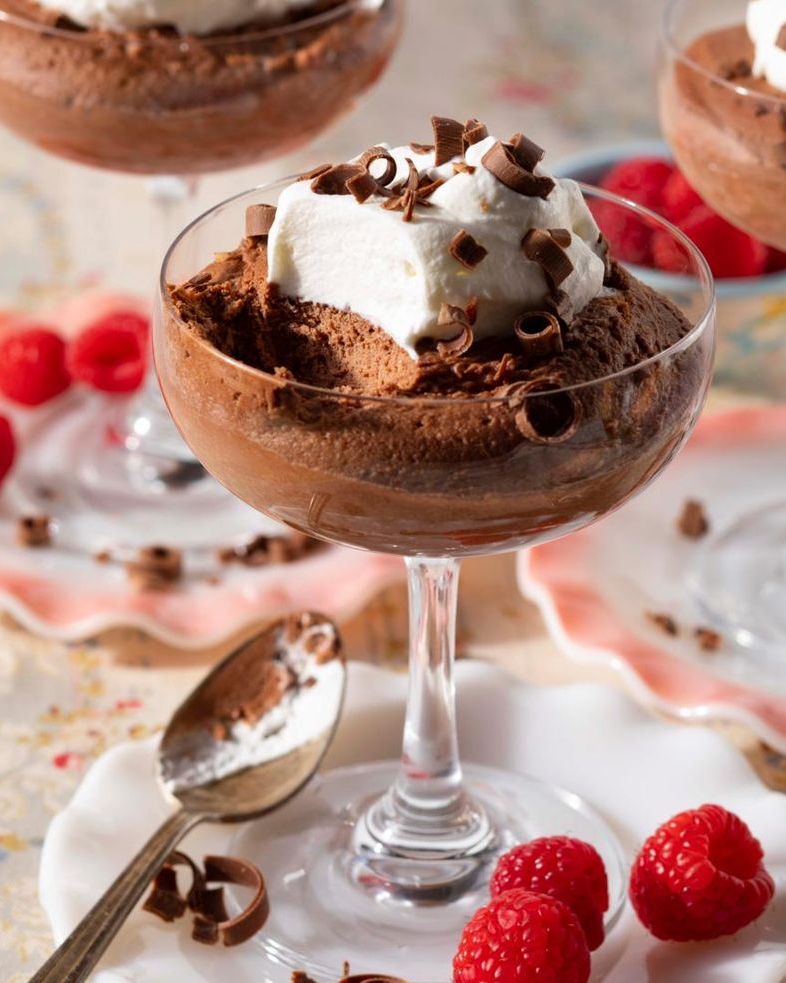 chocolate mousse in cocktail glasses with raspberries
