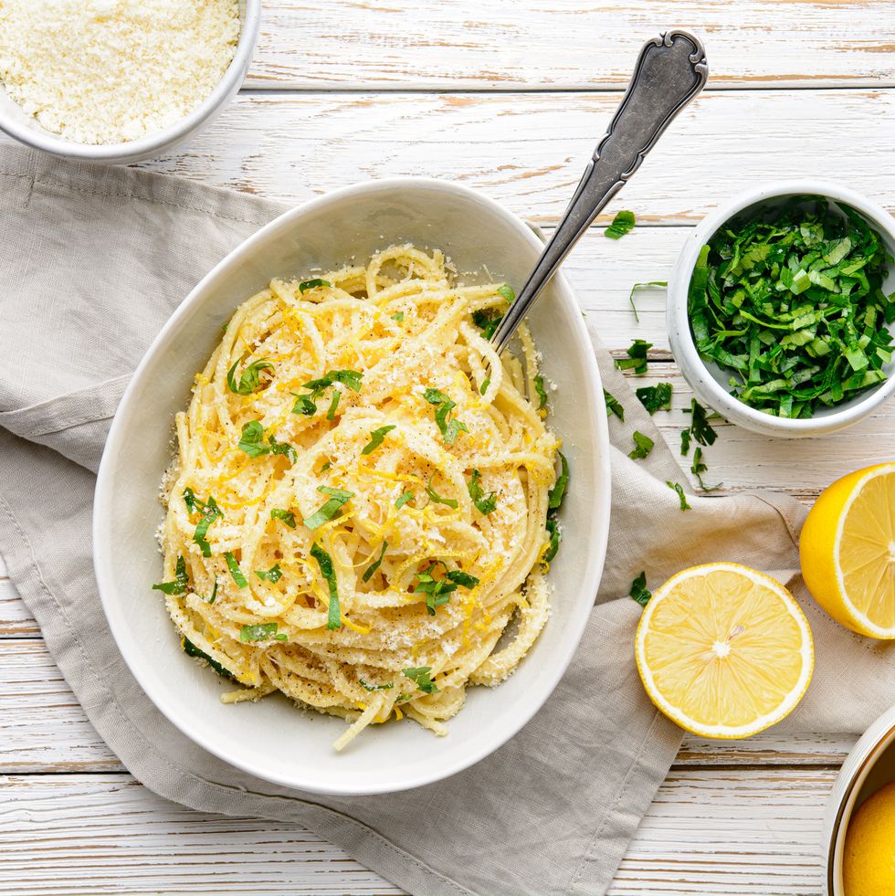 pasta al limone, delicious italian meal, spaghetti with parmesan, butter and lemon sauce, topped with fresh grated zest and cheese